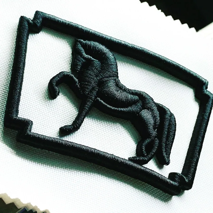Raised 3D embroidery of a horse emblem
