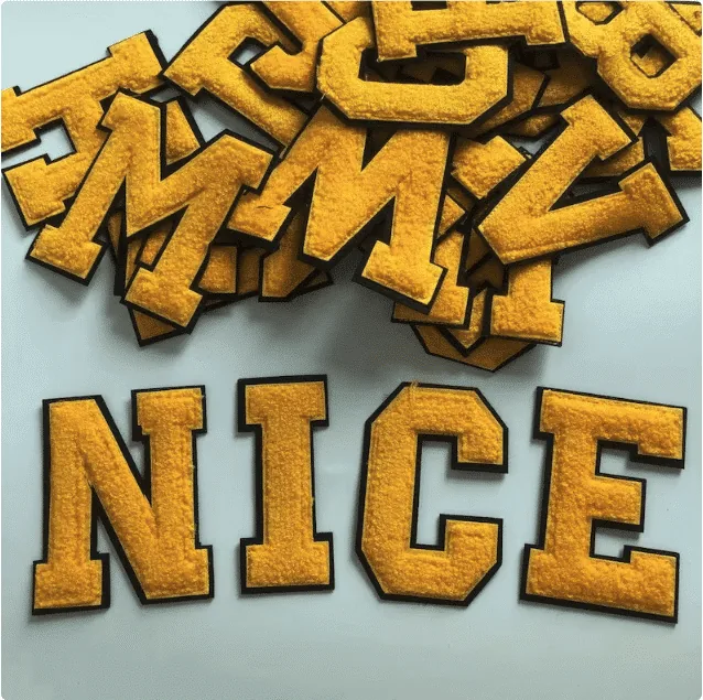 Chenille letters in gold and yellow, embroidery by AJDN